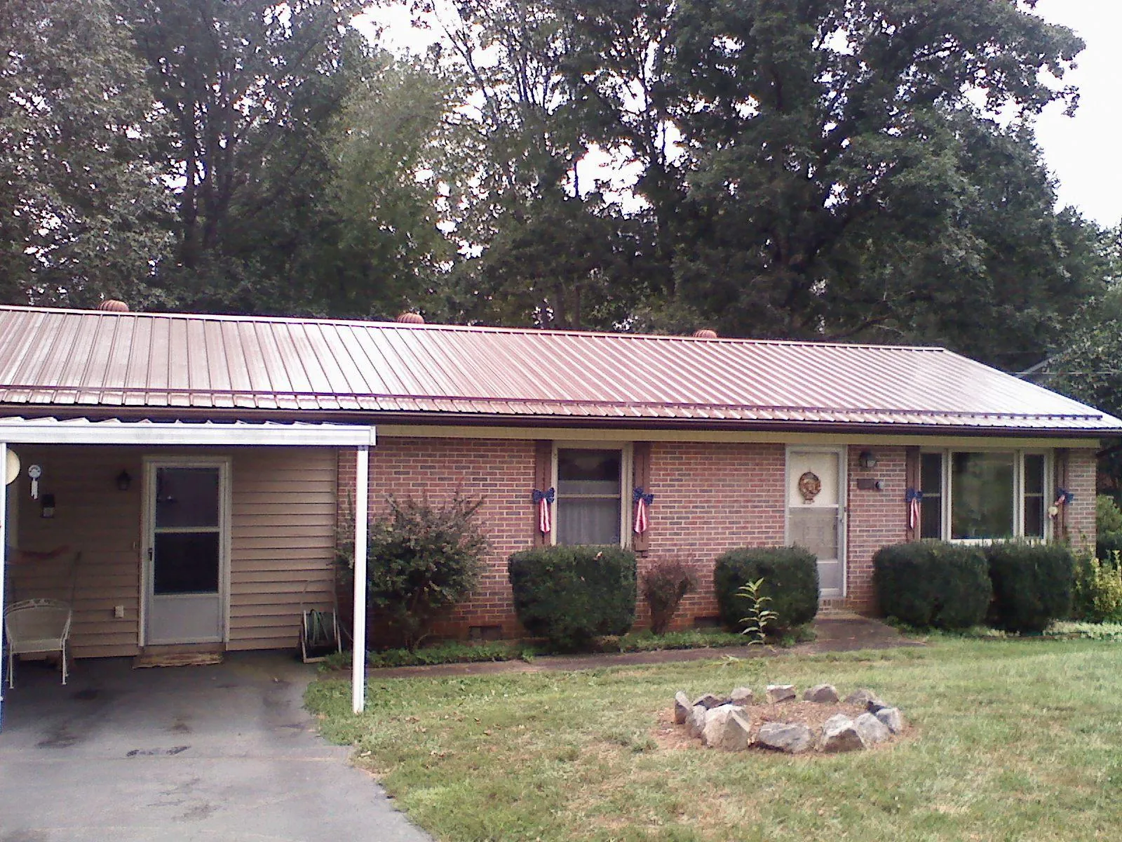 Bronze metal roof and carport on a brick ranch home — Roof Repair work by our crew in North Branch